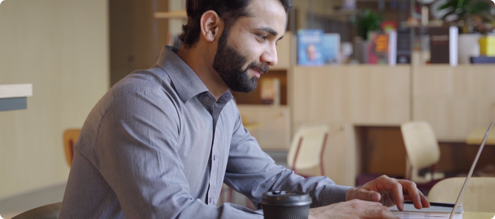 Man working at an laptop in a shared office space.